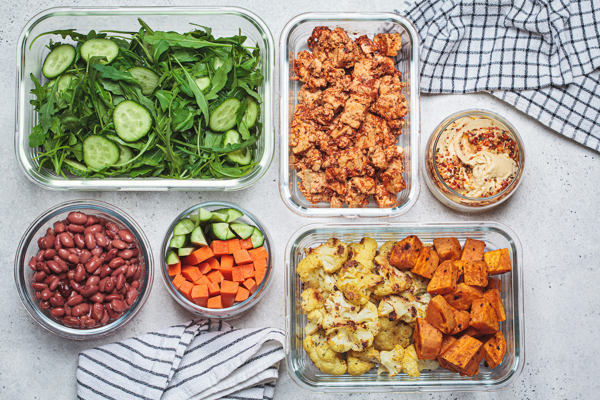 Fresh vegan meal prep food in glass containers.
