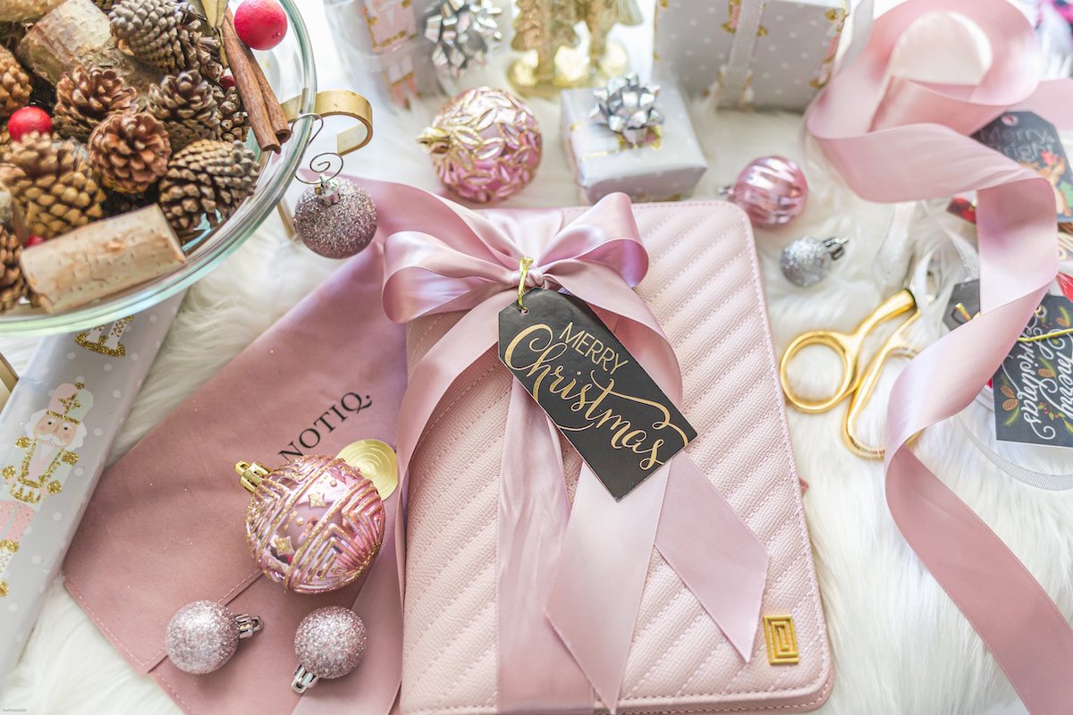 Luxury vegan leather blush quilted agenda with holiday themed background.