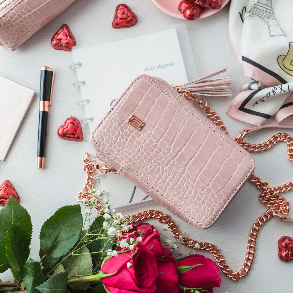 Vegan leather blush croco phone case with flowers and chocolates.