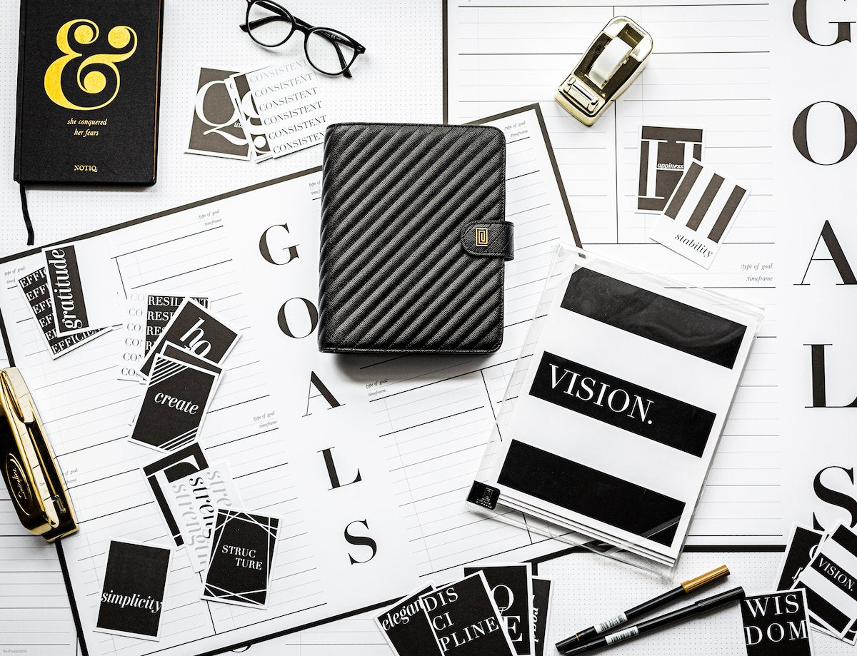 NOTIQ office desk spread with inspirational black and white stationery products.