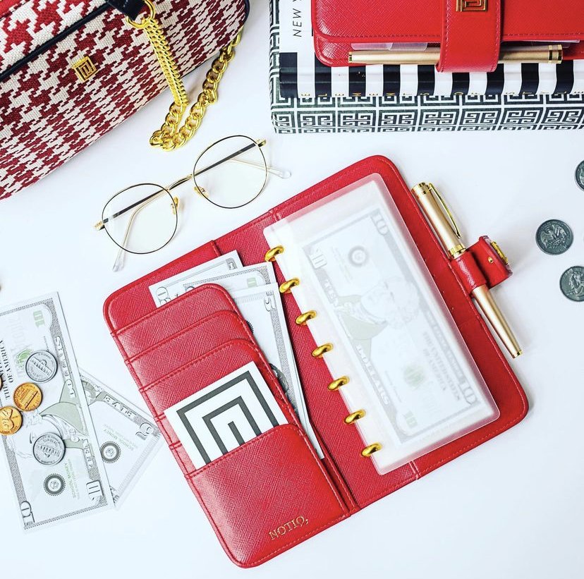 Luxury red finance wallet with budget envelope kit and money.